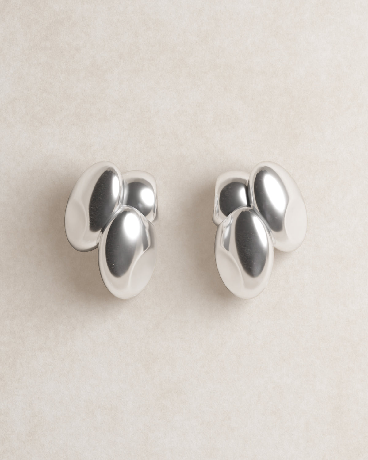 barcelona studs, blob studs, S925, sterling silver, rhodium plated, jewellery, minimal jewellery, sculptural jewellery, model, close up, front view, egg shaped, dented
